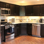 L shaped kitchen with black cupboards